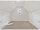 Finished attic space with carpeted floors, built-in storage, and natural light at 2550 Trelipe Dr, Lawrenceville, GA 30044