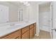 Bathroom featuring double sinks, wood cabinets, and tiled floors at 2550 Trelipe Dr, Lawrenceville, GA 30044