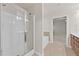 Bright bathroom featuring glass-door shower, a tub, access to the Primary bedroom, and neutral tiles at 2550 Trelipe Dr, Lawrenceville, GA 30044