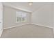 Bright bedroom featuring a window with blinds and neutral paint for a calm atmosphere at 2550 Trelipe Dr, Lawrenceville, GA 30044