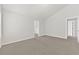 Inviting bedroom with neutral carpet, featuring doorways and a hallway at 2550 Trelipe Dr, Lawrenceville, GA 30044