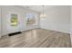 Bright dining room with hardwood floors, wainscoting, chandelier and a door to the outside at 2550 Trelipe Dr, Lawrenceville, GA 30044