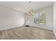 Bright dining room with hardwood floors, wainscoting, chandelier and a door to the outside at 2550 Trelipe Dr, Lawrenceville, GA 30044