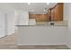 Open-concept kitchen boasts wood cabinets and breakfast bar seating at 2550 Trelipe Dr, Lawrenceville, GA 30044
