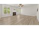 Comfortable living room includes a fireplace, large windows, and ceiling fan at 2550 Trelipe Dr, Lawrenceville, GA 30044
