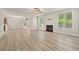 Open-concept living space with fireplace, dining area, and access to kitchen at 2550 Trelipe Dr, Lawrenceville, GA 30044