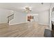 Open-concept living room with hardwood floors and staircase access at 2550 Trelipe Dr, Lawrenceville, GA 30044