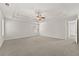 Spacious main bedroom with tray ceiling, fan, and two windows, providing ample light and comfort at 2550 Trelipe Dr, Lawrenceville, GA 30044