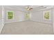 Spacious main bedroom with tray ceiling, fan, and three windows, providing ample light and comfort at 2550 Trelipe Dr, Lawrenceville, GA 30044