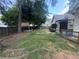 The backyard shows an open green space, wooden fences, a patio area and mature trees at 458 Vinings Vintage Cir, Mableton, GA 30126