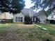 The backyard shows an open green space, patio area, wooden fences, and a view of the home's rear exterior at 458 Vinings Vintage Cir, Mableton, GA 30126