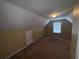 A cozy carpeted bedroom with overhead lighting and a small window at 458 Vinings Vintage Cir, Mableton, GA 30126