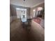 Dining room with carpet, elegant dining table, chairs, lighting, and view into the entryway at 458 Vinings Vintage Cir, Mableton, GA 30126