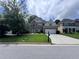Attractive brick home boasts a well-kept lawn and a driveway leading to a two-car garage at 458 Vinings Vintage Cir, Mableton, GA 30126