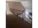 Upstairs hallway with carpet, metal railings, view of the fireplace in the living room below, and natural light at 458 Vinings Vintage Cir, Mableton, GA 30126