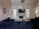 Open-concept living room with fireplace, large windows and dark blue sofa at 458 Vinings Vintage Cir, Mableton, GA 30126