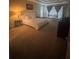 Spacious main bedroom with sitting area, large windows, and neutral carpet at 458 Vinings Vintage Cir, Mableton, GA 30126