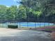 Outdoor community tennis court with blue and green surface surrounded by a fence at 458 Vinings Vintage Cir, Mableton, GA 30126