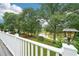 Scenic view from a backyard deck featuring lush trees, a tranquil pond, and landscaping, perfect for relaxation at 528 Savannah Rose Way, Lawrenceville, GA 30045