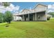 Spacious backyard view with a covered deck area, manicured lawn, and inviting atmosphere at 528 Savannah Rose Way, Lawrenceville, GA 30045