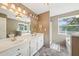 Bright bathroom featuring a double vanity, tub and shower, and ample natural light at 528 Savannah Rose Way, Lawrenceville, GA 30045