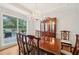 Formal dining area with a wooden table, china cabinet, and a view of the deck at 528 Savannah Rose Way, Lawrenceville, GA 30045