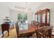 Elegant dining room with hardwood floors, chandelier, and large window at 528 Savannah Rose Way, Lawrenceville, GA 30045