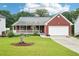 Charming brick home with a well-manicured lawn and a covered front porch at 528 Savannah Rose Way, Lawrenceville, GA 30045