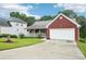 Well-maintained brick house with a front porch, attached garage, and green lawn at 528 Savannah Rose Way, Lawrenceville, GA 30045
