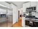 Modern kitchen featuring stainless steel appliances and ample cabinet space at 528 Savannah Rose Way, Lawrenceville, GA 30045