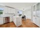 Bright kitchen with white cabinetry, stainless steel appliances, and adjacent dining area at 528 Savannah Rose Way, Lawrenceville, GA 30045