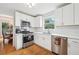 Modern kitchen with stainless steel appliances, white cabinets, and quartz countertops at 528 Savannah Rose Way, Lawrenceville, GA 30045