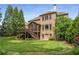 Expansive backyard featuring a screened porch, deck, lush lawn, and mature trees for privacy at 5605 Copper Creek Pass, Cumming, GA 30040