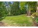 Expansive backyard with lush greenery, mature trees, and staircase leading to upper level at 5605 Copper Creek Pass, Cumming, GA 30040