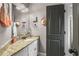 Stylish bathroom featuring granite countertops, decorative mirrors and updated fixtures at 5605 Copper Creek Pass, Cumming, GA 30040