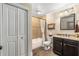Full bathroom with a tub and shower combination, neutral tile, and dark wood vanity at 5605 Copper Creek Pass, Cumming, GA 30040