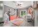 Cozy Bedroom featuring charming decor, including a plush rug, dresser, and window view at 5605 Copper Creek Pass, Cumming, GA 30040