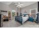 Well-lit bedroom with a blue bed frame, light gray walls, and multiple windows with a view of the outdoors at 5605 Copper Creek Pass, Cumming, GA 30040