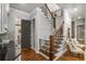 Elegant foyer featuring hardwood floors, staircase with iron railings, and decorative molding at 5605 Copper Creek Pass, Cumming, GA 30040
