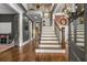 Grand two-story foyer featuring hardwood floors, an elegant staircase, and custom trim work at 5605 Copper Creek Pass, Cumming, GA 30040