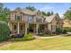 Elegant brick home with covered porch, meticulous landscaping, and timeless curb appeal at 5605 Copper Creek Pass, Cumming, GA 30040