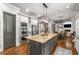 Spacious kitchen featuring a large island, stainless steel appliances, and an open layout into the breakfast area at 5605 Copper Creek Pass, Cumming, GA 30040