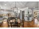 Open kitchen features an island, stainless steel appliances, and adjacent round breakfast table for casual dining at 5605 Copper Creek Pass, Cumming, GA 30040