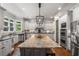 Gourmet kitchen with a large center island, stainless steel appliances, and custom white cabinetry at 5605 Copper Creek Pass, Cumming, GA 30040