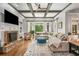 Inviting living room with coffered ceiling, a stone fireplace, and abundant natural light at 5605 Copper Creek Pass, Cumming, GA 30040