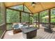 Relaxing screened porch with wood ceilings, comfortable seating and an outdoor fireplace at 5605 Copper Creek Pass, Cumming, GA 30040