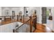 Upstairs landing showcasing hardwood floors, iron railing, and view of downstairs at 5605 Copper Creek Pass, Cumming, GA 30040