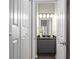 A charming bathroom features a gray vanity with a black marble countertop and decorative lighting at 735 Ponce De Leon Pl Ne Unit 1, Atlanta, GA 30306