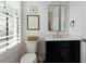 Stylish powder room features a modern vanity, black cabinetry, updated fixtures, and natural light at 302 Boxwood Ln, Roswell, GA 30075