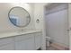 Well-lit bathroom with a round mirror and shower with curtain at 302 Boxwood Ln, Roswell, GA 30075